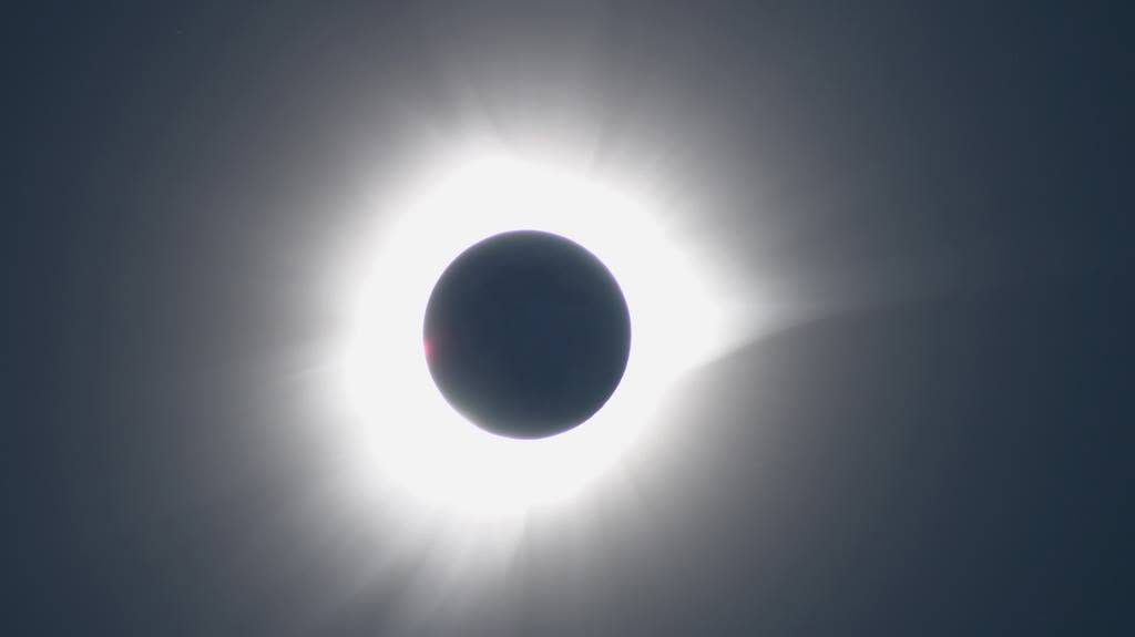 Mid-eclipse over Tidore, the corona visible